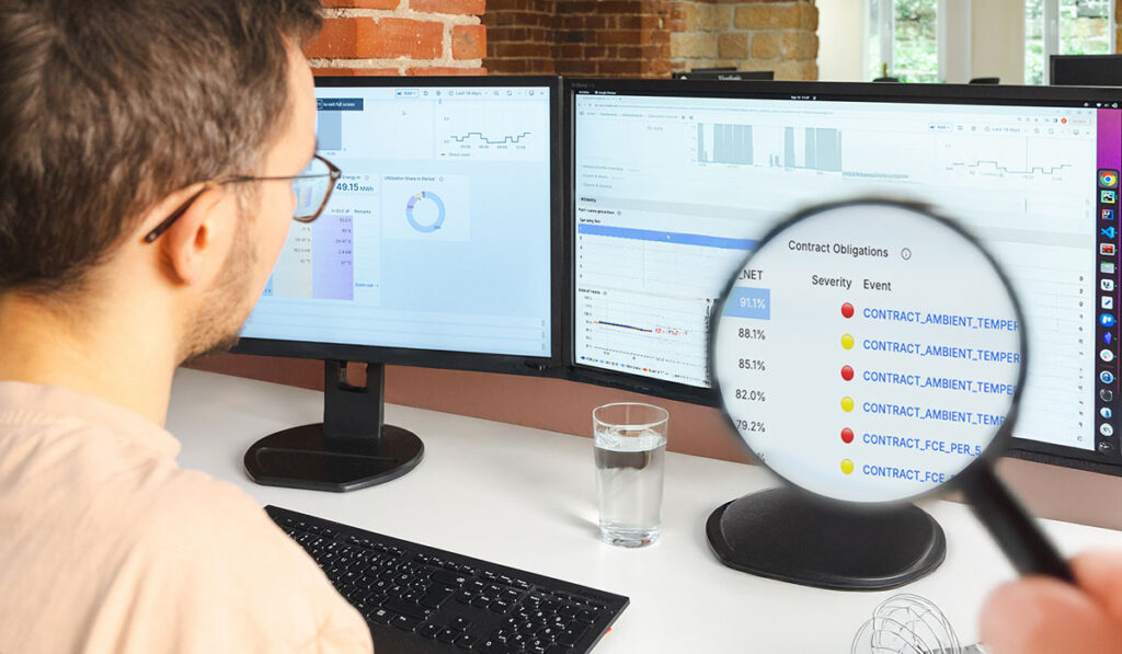 A man sitting in front of a screen with a contract tracker to simplify battery warranty compliance